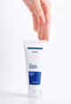 Hand holding Fused Ceramide Hand Cream tube with Kojic Acid