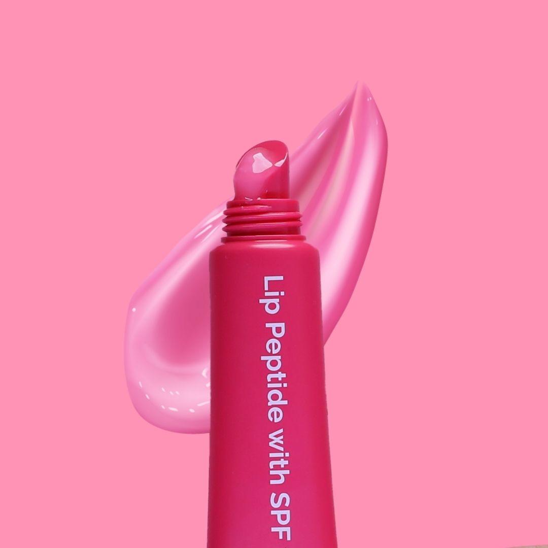 Glossy pink Lip Peptide swatch texture with SPF 15 tube by Fused Skincare
